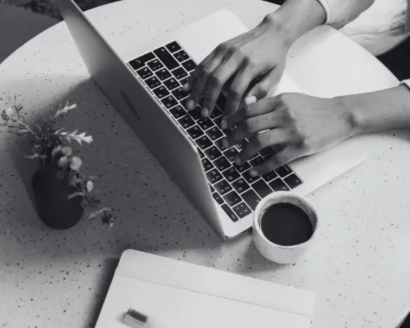 Image of a person typing on a computer